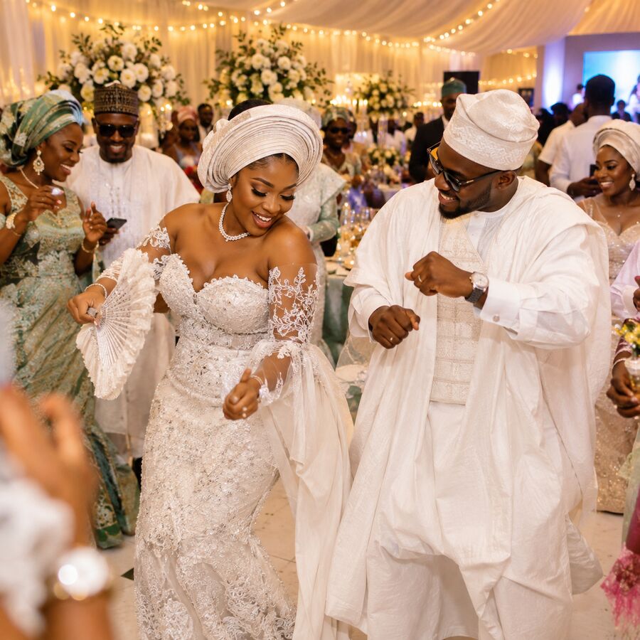 A white wedding reception with Nigerian wedding guests